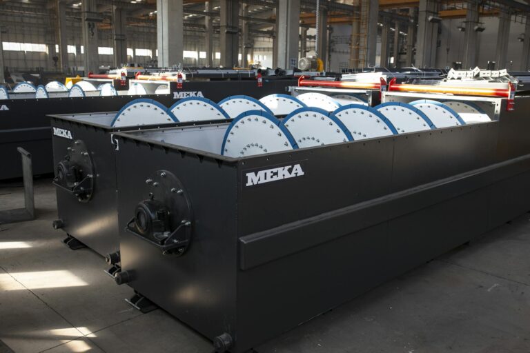 Large industrial machinery inside a modern manufacturing plant with natural lighting.