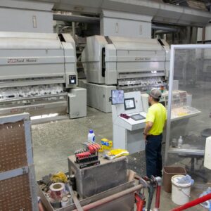Workers operating machinery in a cotton gin factory in North Carolina