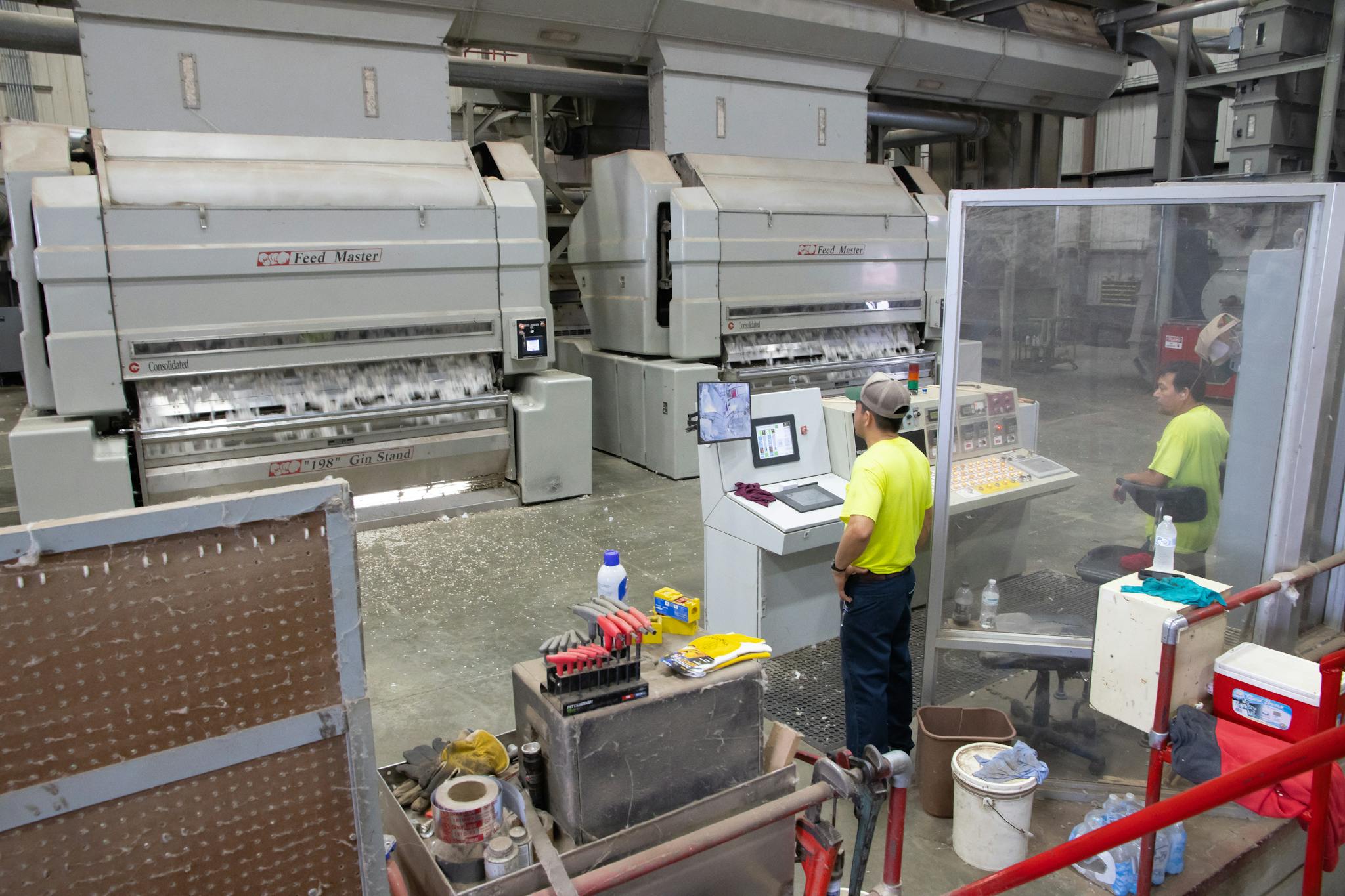 Home Workers Operating Machinery In A Cotton Gin